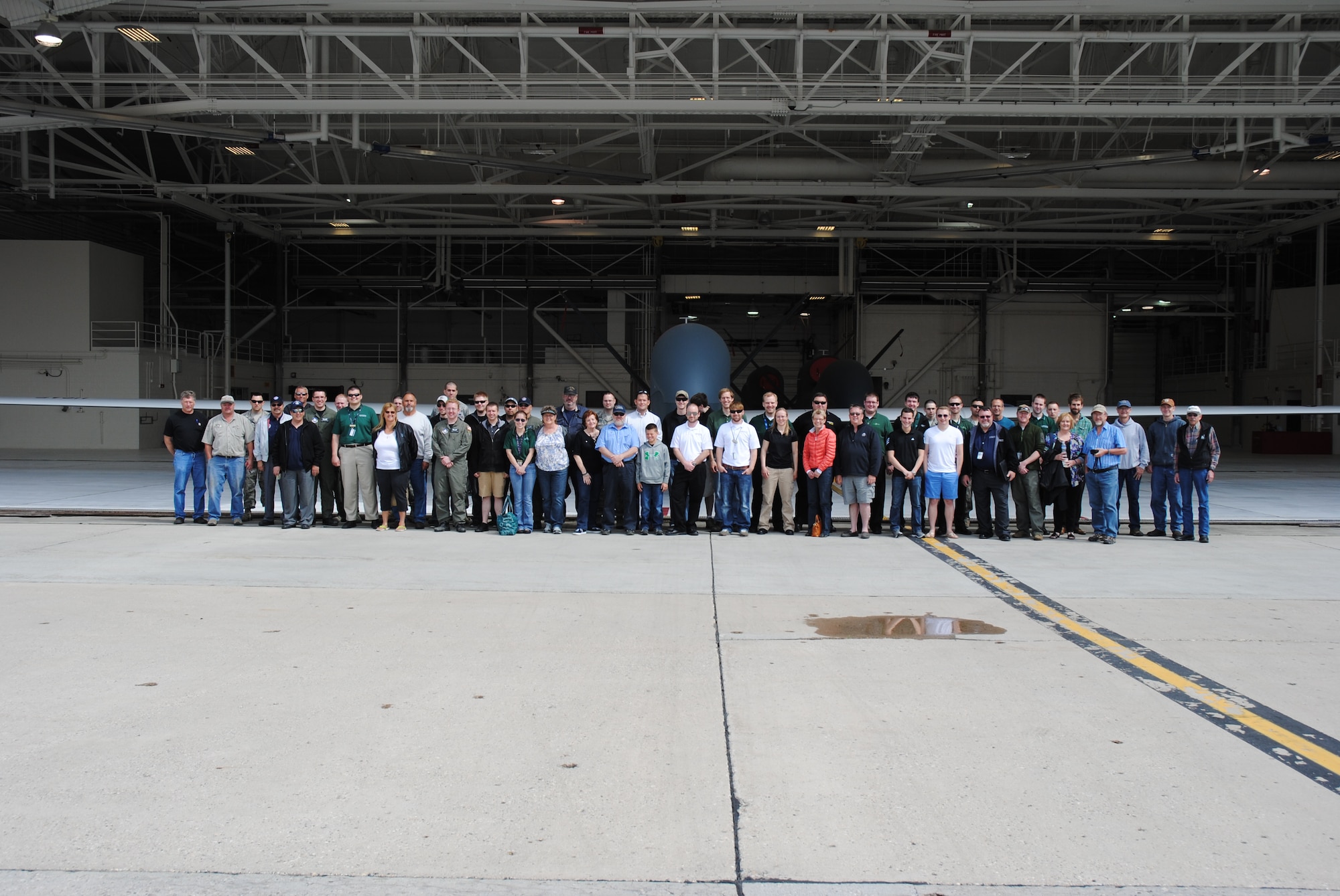 Guests, civilians and Airmen participating in the 2014 M.A.C.A. Civil Fly-In pose for a group photo in front of a RQ-4 Block 40 Global Hawk on June 14, 2014, at the flightline on Grand Forks Air Force Base, N.D. The viewing of the Global Hawk was one of the highlights featured on the tour guests were treated during the civil fly-in for the Mid-Air Collision Avoidance program managed by the 319th Air Base Wing Safety Office. (U.S. Air Force photo/Staff Sgt. Luis Loza Gutierrez) 