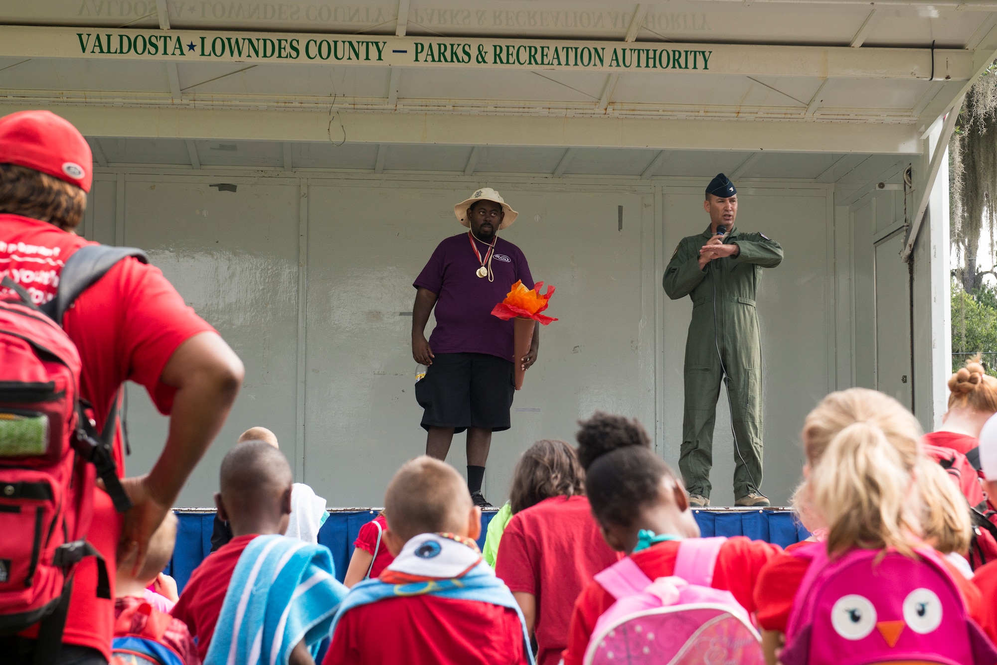 U.S. Air Force Col. Chad Franks, right, 23d Wing commander, and Lewis Gordan, Special Olympics Georgia athlete, give opening remarks at Moody’s Olympic Day celebration at Grassy Pond in Lake Park, Ga., June 13, 2014. Olympic Day allowed children to compete in various sports promoting the Olympic ideals: fair play perseverance, respect and sportsmanship. (U.S. Air Force photo by Airman 1st Class Ryan Callaghan/Released)