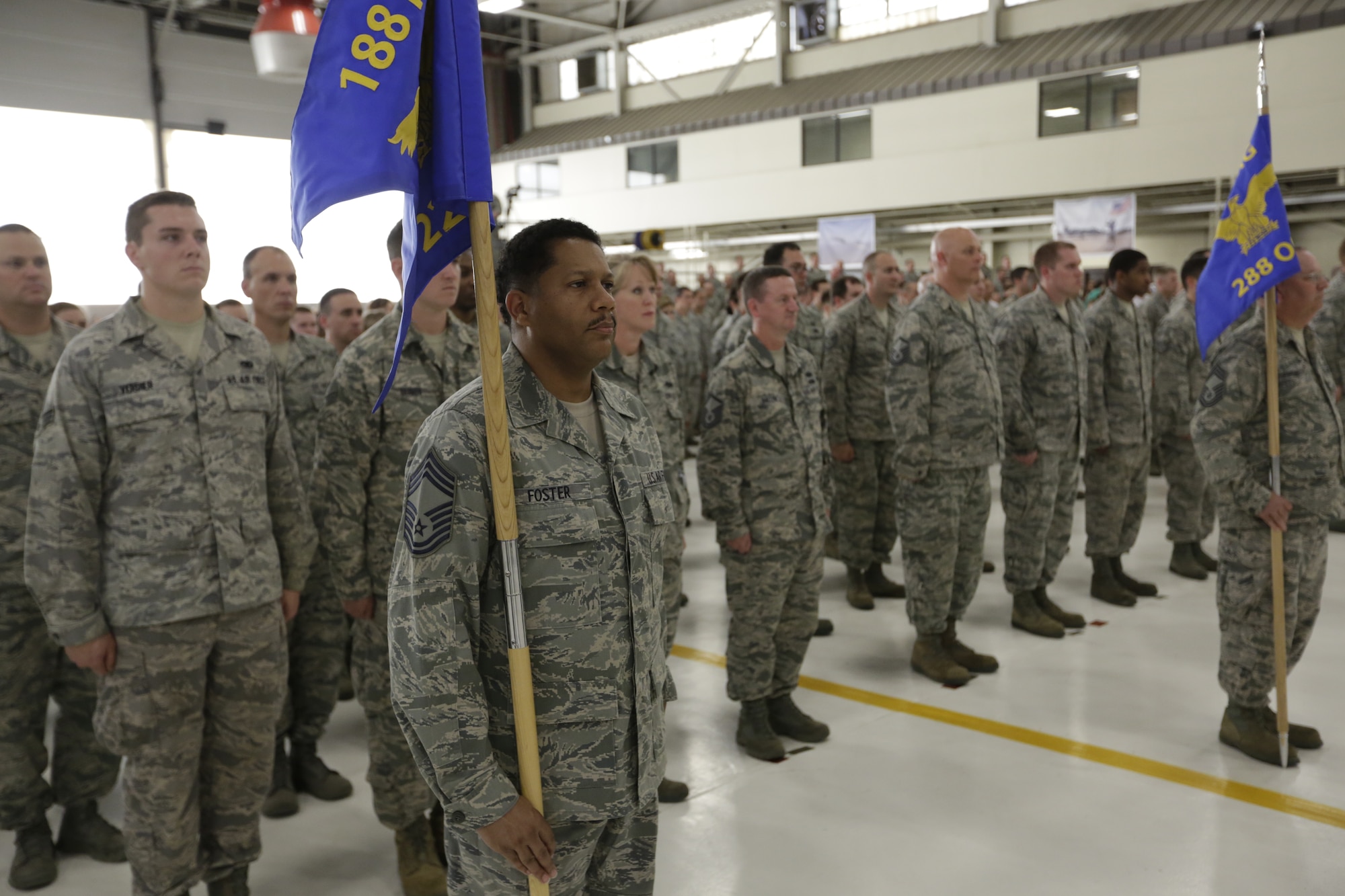 Chief Master Sgt. Kevin Foster holds the 223rd Intelligence Support Squadron guidon during a Conversion Day ceremony at Ebbing Air National Guard Base, Fort Smith, Arkansas, June 7, 2014. The ceremony recognized the many changes occurring at the wing as a result of its conversion to a remotely piloted aircraft (MQ-9 Reapers) and intelligence, surveillance and reconnaissance mission. (U.S. Air National Guard photo by Master Sgt. Mark Moore)