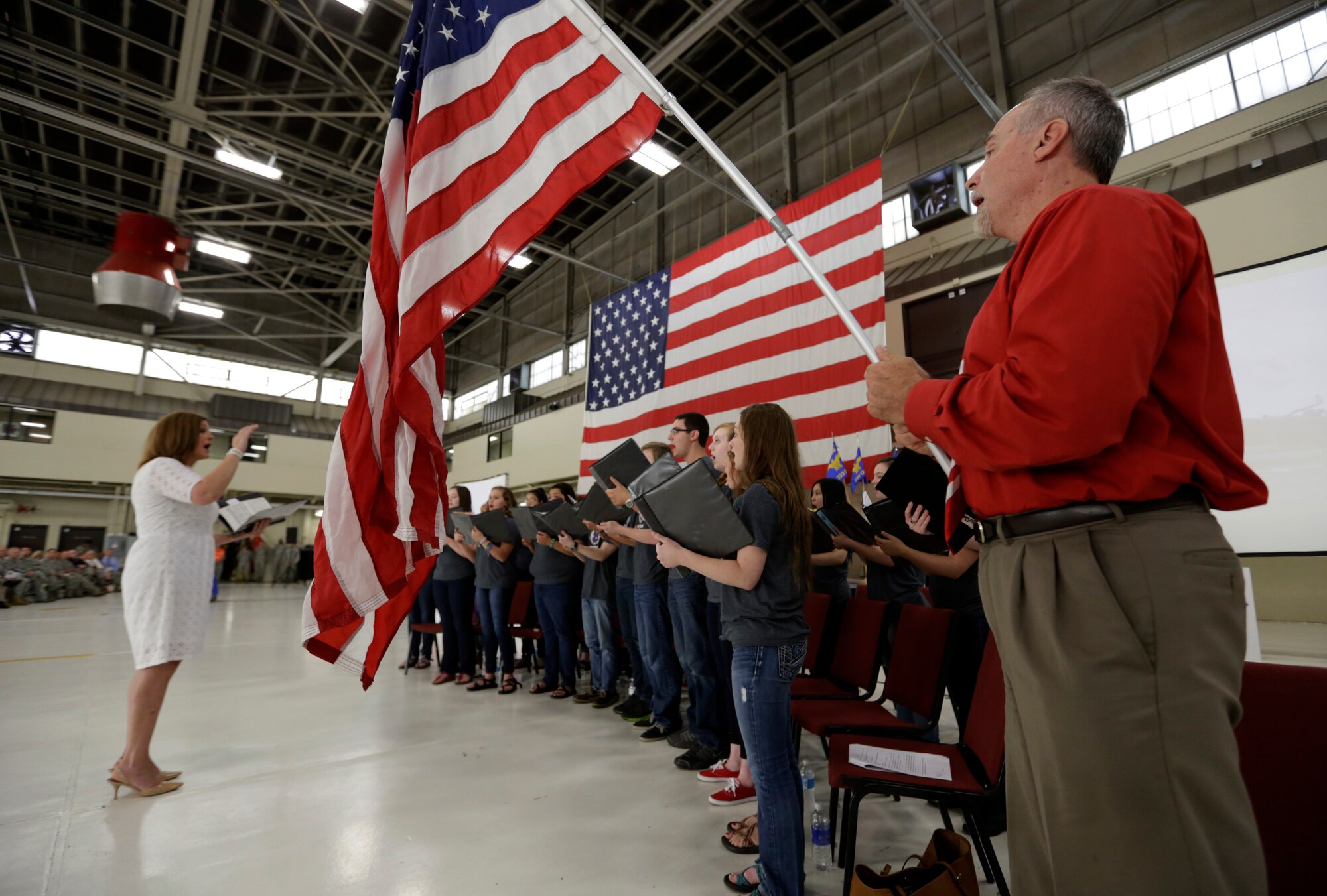 The Fort Smith Southside High School choir accompanied by Dave Burns performs “America the Beautiful” during a Conversion Day ceremony at Ebbing Air National Guard Base, Fort Smith, Arkansas, June 7, 2014. The ceremony recognized the many changes occurring at the 188th Wing as a result of its conversion to a remotely piloted aircraft (MQ-9 Reapers) and intelligence, surveillance and reconnaissance mission. (U.S. Air National Guard photo by Master Sgt. Mark Moore)