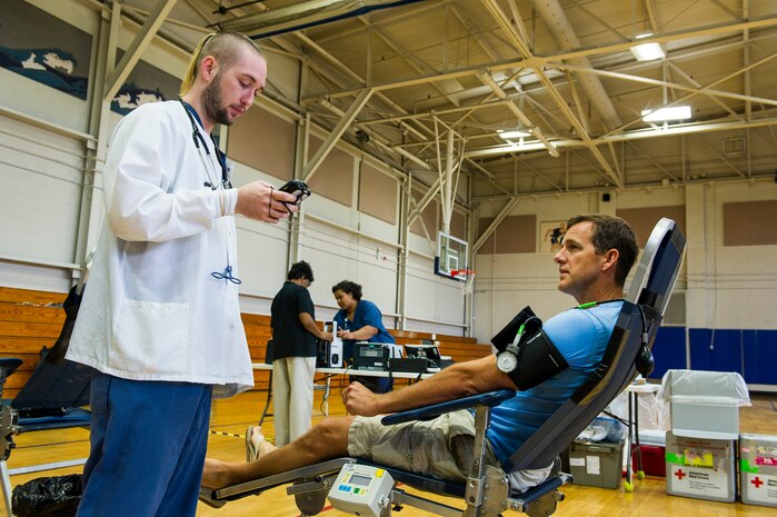 A member of the American Red Cross prepares John Lackey, 628th Security Forces Squadron police officer, to donate blood, at the Air Base Gym, June 12, 2014, at Joint Base Charleston, S.C. Members of JB Charleston had the opportunity to donate blood inside the Air Base gym with the help of the American Red Cross, which utilizes volunteers to aid those in need during emergency situations.  (U.S. Air Force photo/Senior Airman George Goslin)