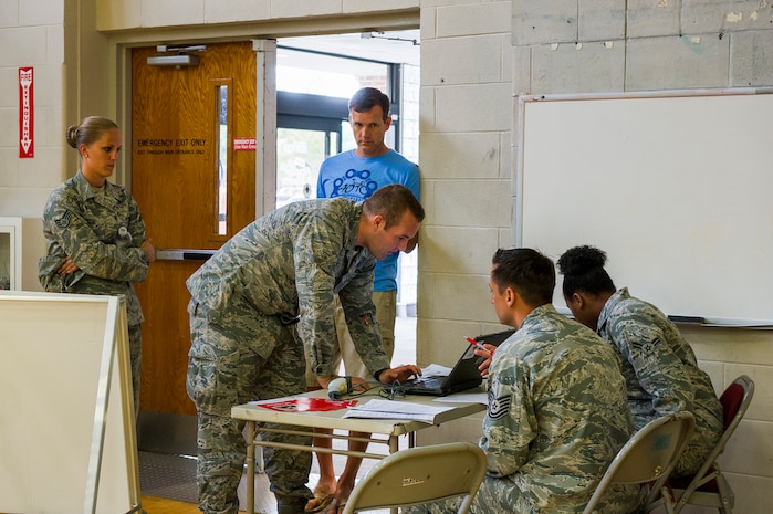 Members of Joint Base Charleston sign in for a blood drive at the Air Base gym, June 12, 2014, at Joint Base Charleston, S.C. Team Charleston members had the opportunity to donate blood with the help of the American Red Cross, which utilizes volunteers to aid those in need during emergency situations.  (U.S. Air Force photo/Senior Airman George Goslin)
