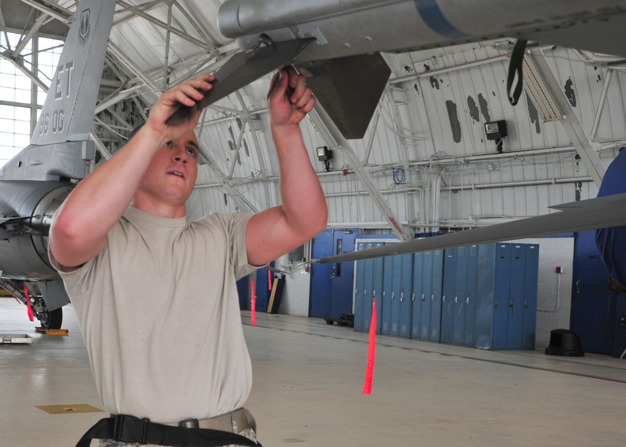 Airman 1st Class Trey Riley, of the 96h Aircraft Maintenance Squadron Blue, ensures the fins are properly secure to a CATM-120 missile on an F-16 Fight Falcon during the 96th Maintenance Group’s quarterly weapons load crew competition June 13 at Eglin Air Force Base, Fla.  Riley, Staff Sgt. Taleisan Colby and Airman 1st Class Caitlyn Nolin lost to the Red AMU F-15 team.  (U.S. Air Force photo/Ilka Cole)