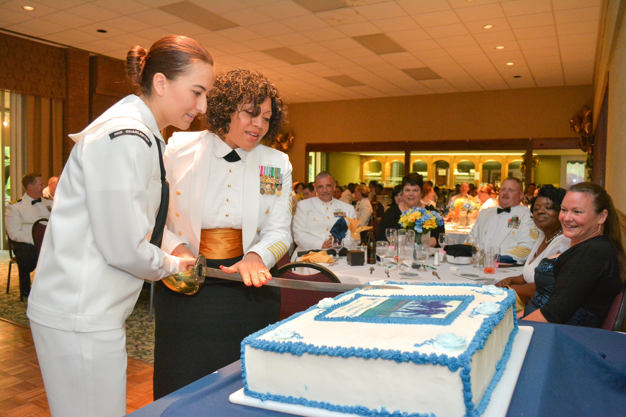Master Chief Petty Officer Betty Waton, Naval Health Clinic Charleston command master chief, and Hospital Corpsman Lauren Knouse, also from NHCC, cut a cake celebrating the 116th birthday of the Navy Hospital Corpsman rating during NHCC's Hospital Corps Ball June 14, 2014 at the Storm Point Conference Center on Joint Base Charleston. (U.S. Navy photo/Sasha Fimiani)
