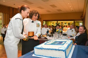 Master Chief Petty Officer Betty Waton, Naval Health Clinic Charleston command master chief, and Hospital Corpsman Lauren Knouse, also from NHCC, cut a cake celebrating the 116th birthday of the Navy Hospital Corpsman rating during NHCC's Hospital Corps Ball June 14, 2014 at the Storm Point Conference Center on Joint Base Charleston. (U.S. Navy photo/Sasha Fimiani)
