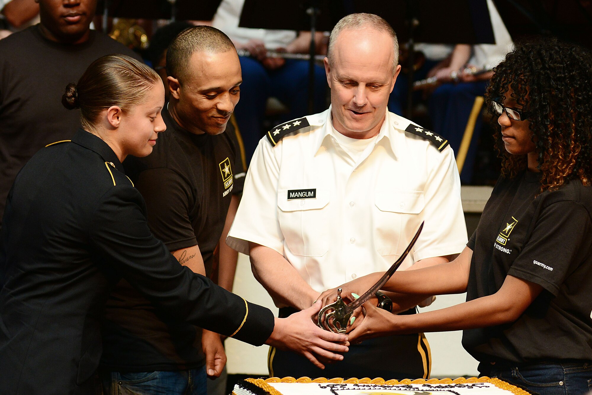 From the left, U.S. Army Pvt. Natalie Peterson, 128th Aviation Brigade, Justin Cooke, Delayed Entry Program member, Lt. Gen. Kevin Mangum, TRADOC deputy commanding general, chief of staff and Shakira Smith, DEP member, cut the Army Birthday cake during the 239th Army birthday concert and streamer ceremony at Fort Eustis, Va., June 12, 2014. These members represented the oldest and youngest Soldiers at the installation, and the youngest and oldest of the recently enlisted recruits. (U.S. Air Force photo by Airman 1st Class Kimberly Nagle/Released) 