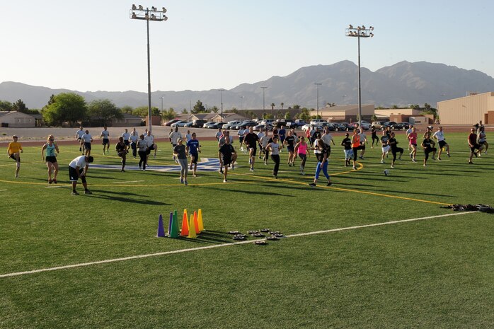 Members of the Nellis community participate in a Warrior Trained Fitness workout June 12, 2014, at Nellis Air Force Base, Nev.  WTF is a high-intensity workout designed as part of the “Life of a Warrior” concept encouraging individuals to live a healthier lifestyle. (U.S. Air Force photo by Tech. Sgt. Taylor Worley)
