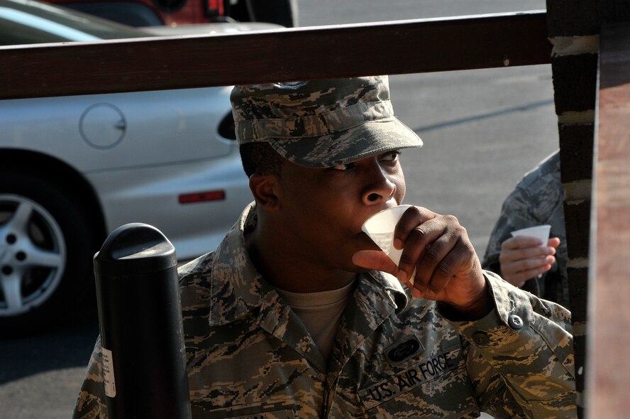 MCGHEE TYSON AIR NATIONAL GUARD BASE, Tenn. - Air National Guard Airmen from across the nation take a water break here June 17, 2014, with the late morning heat index rising on the parade ground of the I.G. Brown Training and Education Center. The Airmen are students in satellite Airman Leadership School and performed their summative evaluation for drill and ceremony. (U.S. Air National Guard photo by Master Sgt. Mike R. Smith/Released)