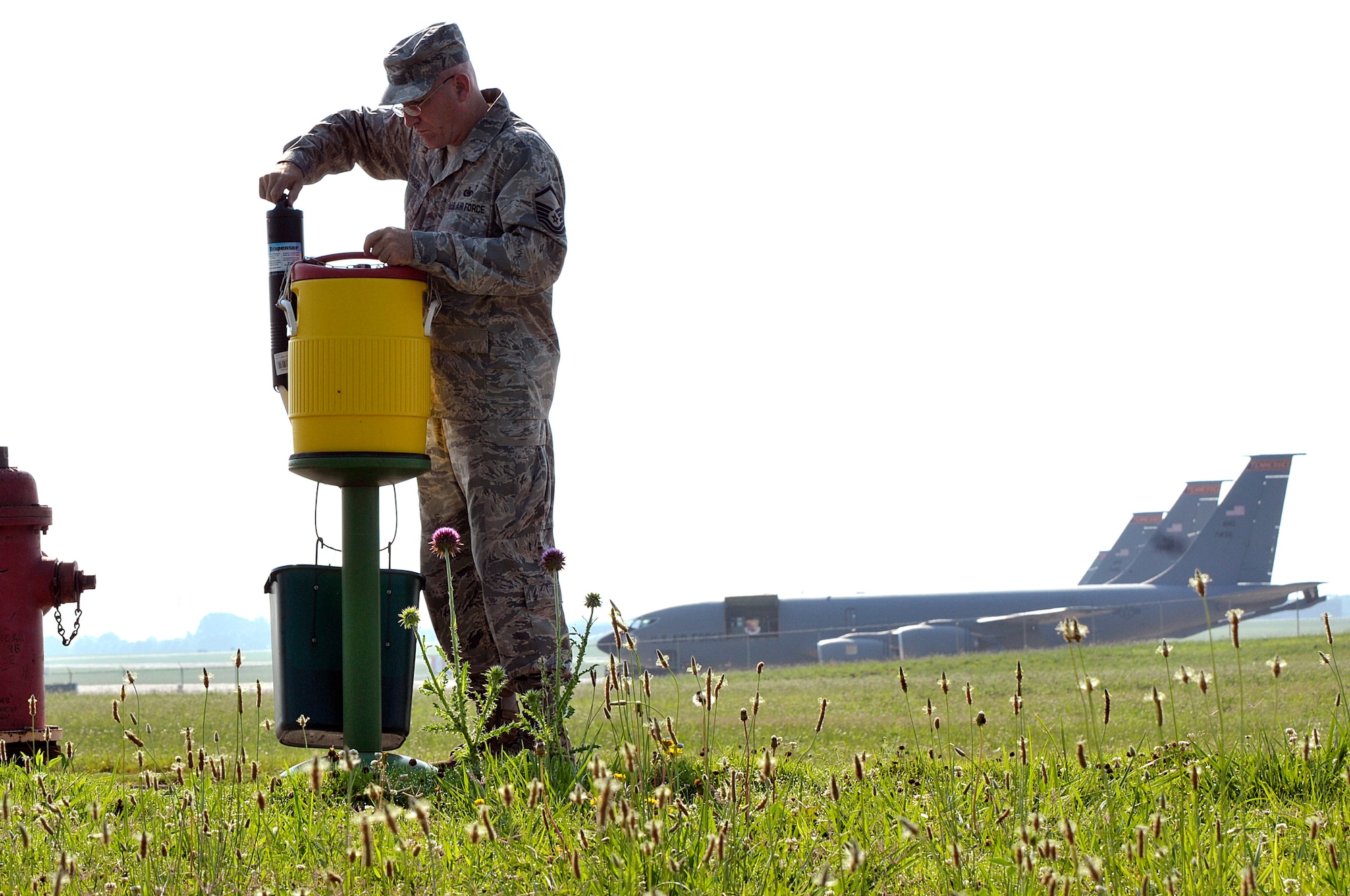 MCGHEE TYSON AIR NATIONAL GUARD BASE, Tenn. - Master Sgt. Don Pierson, logistics manager for the I.G. Brown Training and Education Center, checks the water cooler here June 17, 2014, on the base perimeter road used by runners. Pierson fills several coolers with ice and water three days a week to ensure service members stay cool and hydrated. The day's forecasted high temperature was 90 degrees. (U.S. Air National Guard photo by Master Sgt. Mike R. Smith/Released)
