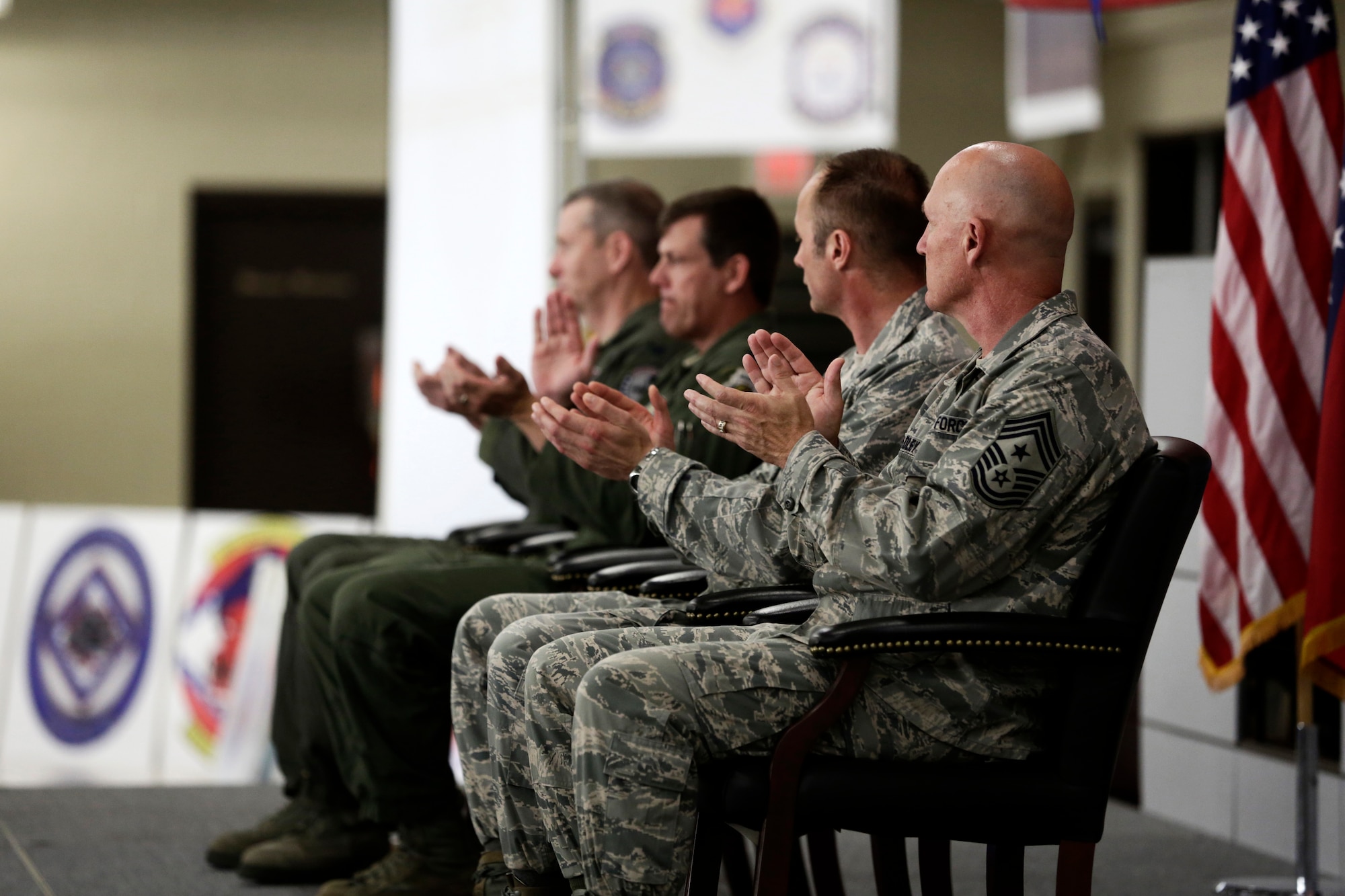 Col. Mark Anderson, 188th Wing commander; Col. Brian Burger, 188th Operations Group commander; Lt. Col. Robert Kinney, 188th Intelligence, Surveillance and Reconnaissance Group commander; and Chief Master Sgt. Stephen Bradley, 188th Wing command chief, applaud following a speech delivered by Lt. Col. Anderson Neal, out-going 188th Maintenance Group commander, following the inactivation of the 188th Maintenance Group, 188th Maintenance Squadron, 188th Aircraft Maintenance Squadron and 188th Maintenance Operations Flight during a Conversion Day ceremony at Ebbing Air National Guard Base, Fort Smith, Arkansas, June 7, 2014. The ceremony recognized the many changes occurring at the wing as a result of its conversion to a remotely piloted aircraft (MQ-9 Reapers) and intelligence, surveillance and reconnaissance mission. (U.S. Air National Guard photo by Master Sgt. Mark Moore)