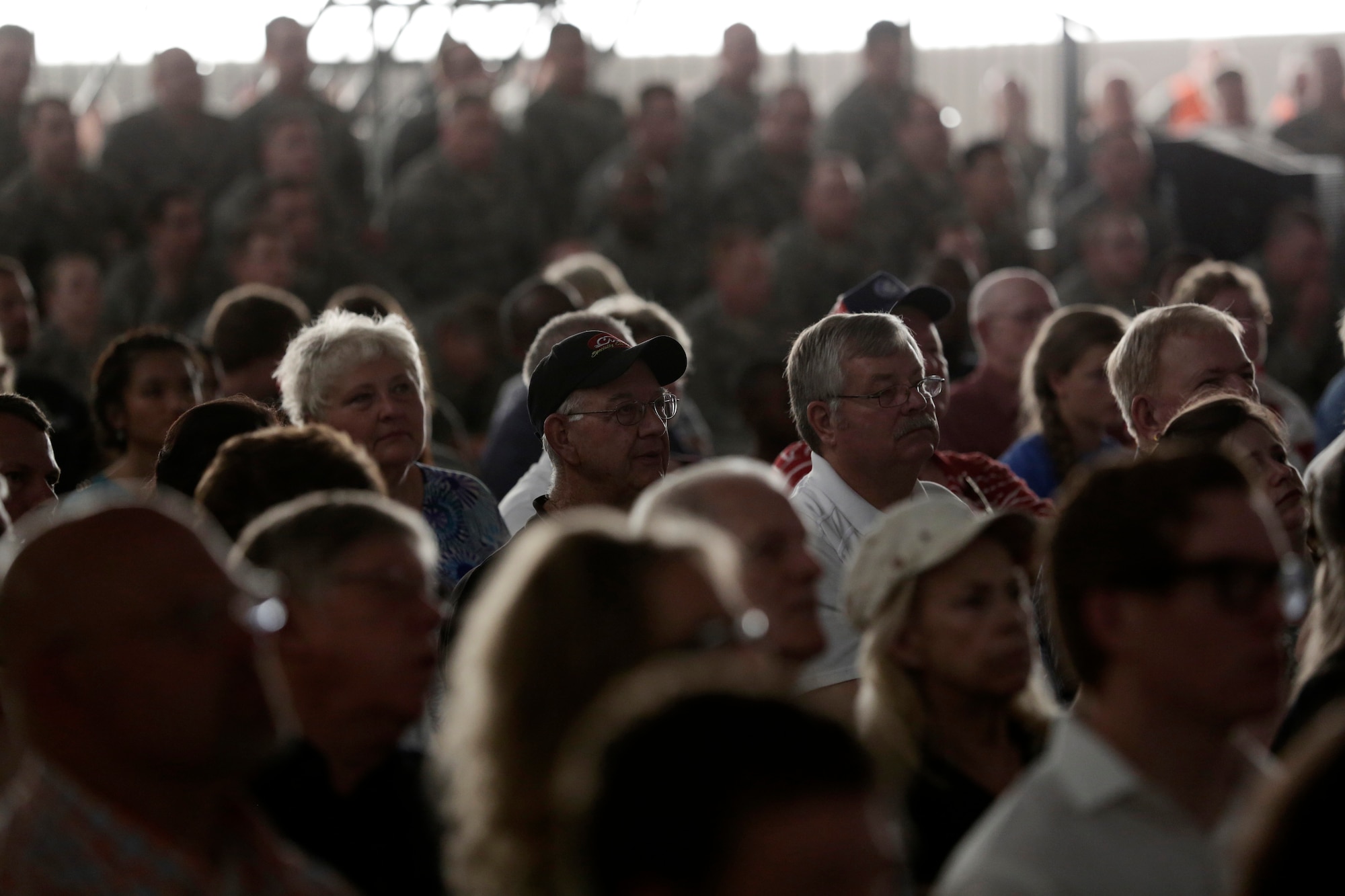 Event attendees watch an imagery slide show presentation during a Conversion Day ceremony held at Ebbing Air National Guard Base, Fort Smith, Arkansas, June 7, 2014. The ceremony recognized the many changes occurring at the wing as a result of its conversion to a remotely piloted aircraft (MQ-9 Reapers) and intelligence, surveillance and reconnaissance mission. The 188th Fighter Wing was redesignated as the 188th Wing during the event. (U.S. Air National Guard photo by Master Sgt. Mark Moore)