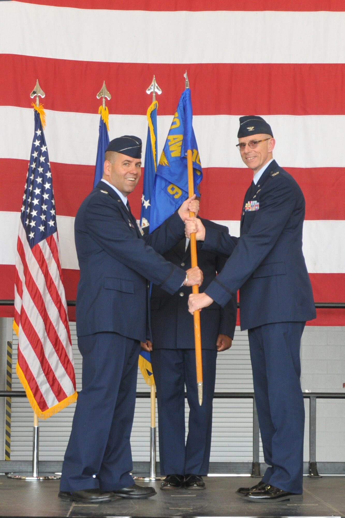 Col. Kevin Riley, new 910th Mission Support Group commander, accepts the squadron guidon from Col. James D. Dignan, 910th Airlift Wing commander, during an assumption of command ceremony in a hangar here, June 7, 2014. During the ceremony, Riley took command of the 910th Mission Support Group, the largest at Youngstown, consisting of more than 600 Airmen and six squadrons. U.S. Air Force photo/Tech. Sgt. Jim Brock.