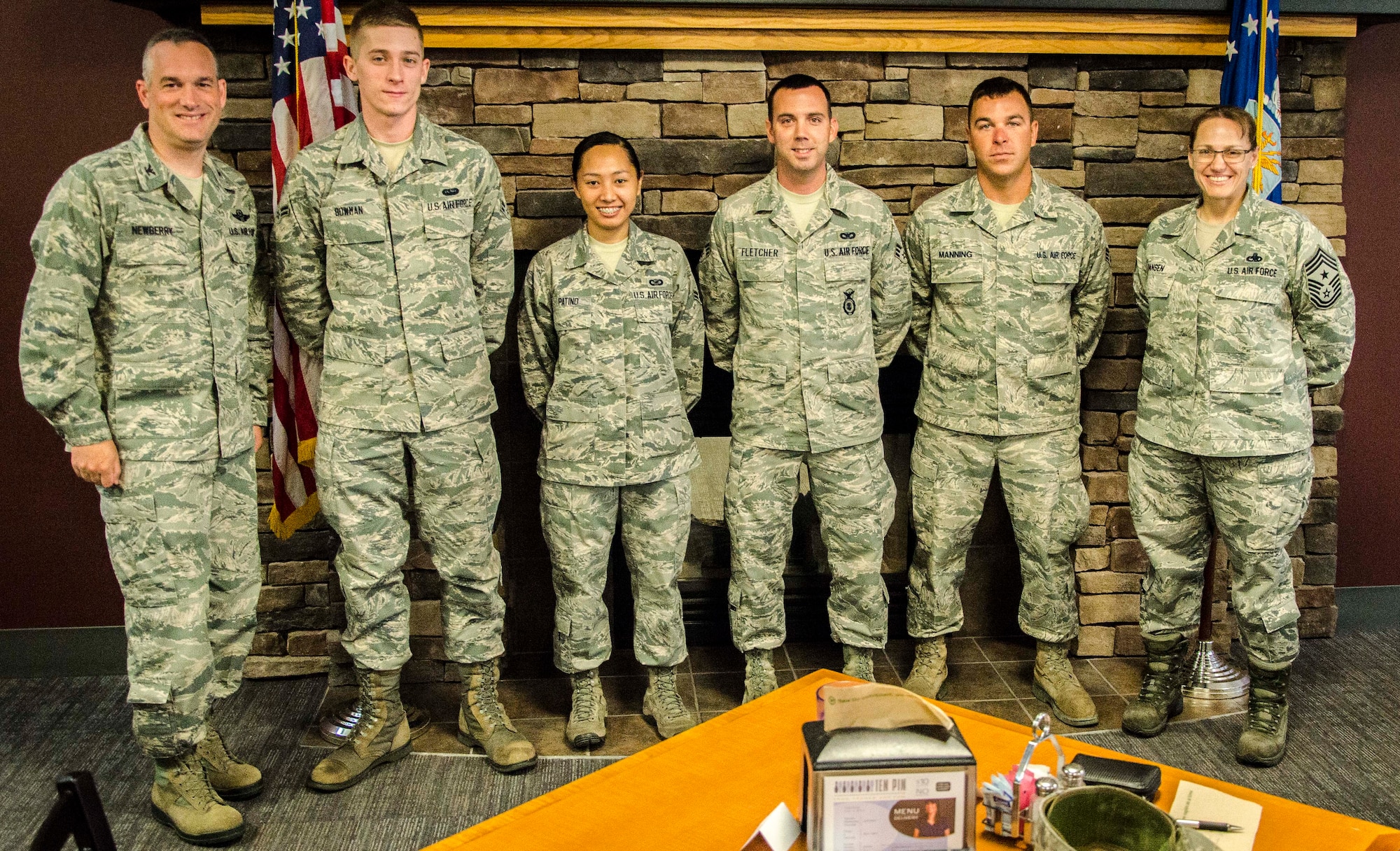 Senior Airmen Clinton Manning and Charles Fletcher and Airmen 1st Class Janelle Patiño and Garrett Bowman pose with Col. Brian Newberry and Chief Master Sgt. Wendy Hansen during the monthly Diamond Sharp first sergeant recognition ceremony in the Warrior Dining Facility at Fairchild Air Force Base, Wash., June 17, 2014. “Diamond Sharp is one of our marquee events of the month--along with our monthly promotion ceremony,” Newberry said. “It is a chance to celebrate our Airmen who are advancing the call.” The colonel said June's Diamond Sharp was no different with the wing’s Airmen standing tall with a "can do" attitude, particularly stepping up with excellent airshow coverage. Newberry is the 92nd Air Refueling Wing commander and Hansen is the 92nd ARW command chief. Manning is a 92nd Civil Engineer Squadron heavy equipment operator and Fletcher is a 92nd Security Forces Squadron installation patrolman. Patiño is a 92nd ARW public affairs photojournalist and Bowman is a 36th Rescue Flight administrative assistant. If interested in submitting an Airman for Diamond Sharp, contact your unit first sergeant for more information. (U.S. Air Force photo by Staff Sgt. Benjamin W. Stratton/Released)