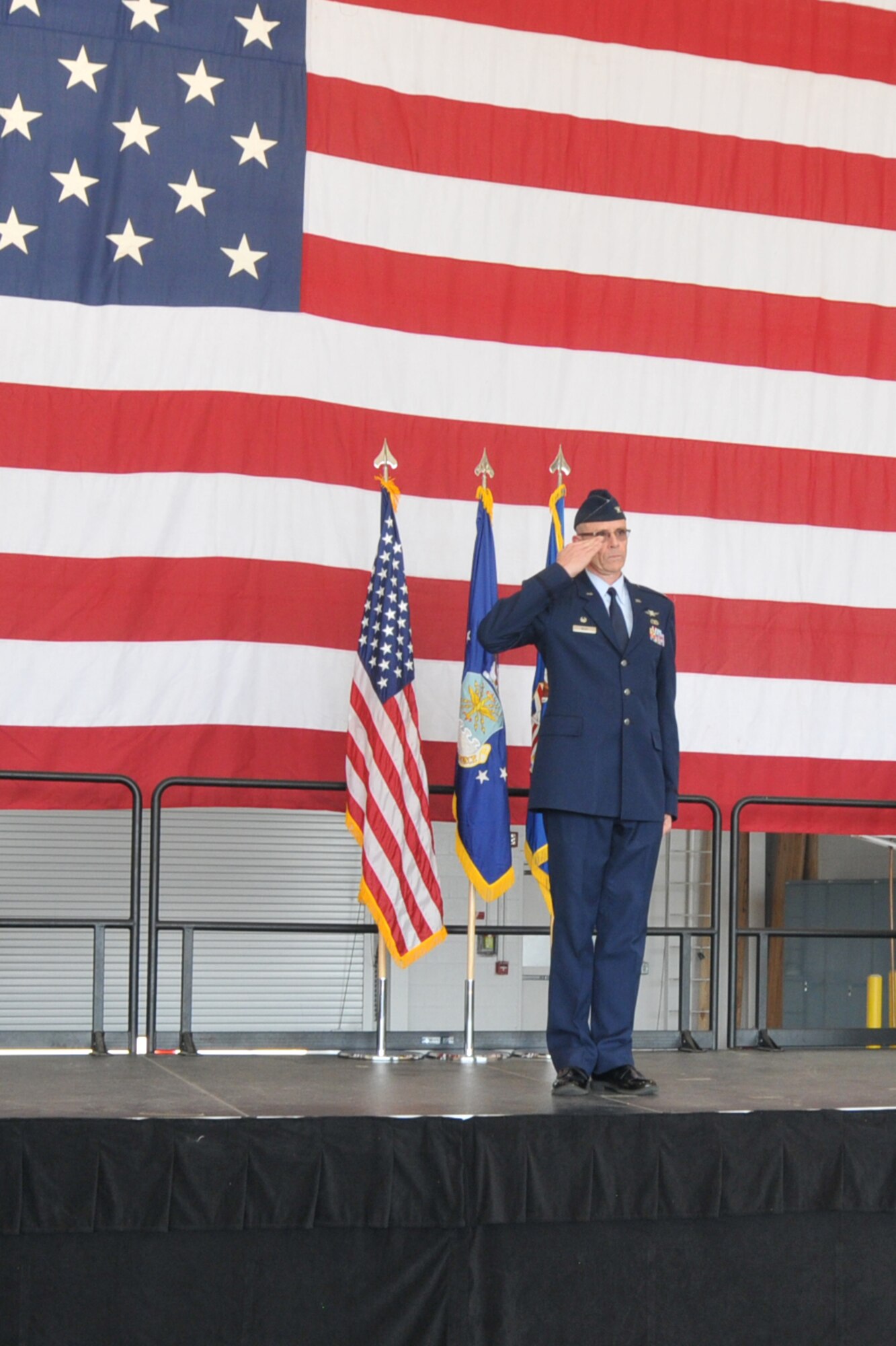 Col. Kevin Riley salutes at the end of an assumption of command ceremony in a hangar here, June 7, 2014. During the ceremony, Riley took command of the 910th Mission Support Group, the largest at Youngstown, consisting of more than 600 Airmen and six squadrons. 