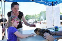 Jutta Nabity and her grandchild Mackenzie Nabity pet a guinea pig during the Offutt Advisory Council’s annual Offutt Appreciation Day Picnic held at the Offutt Base Lake on Offutt Air Force Base, Nebraska, June 6. The activities were only a small portion of the event there was also free food, drinks, live entertainment and trivia for prizes. (U.S. Air Force photo by Charles Haymond/Released)