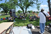 Team Offutt members enjoy the songs from Rick Spurgeon and Out of the Fire band during the Offutt Advisory Council’s annual Offutt Appreciation Day Picnic held at the Offutt Base Lake on Offutt Air Force Base, Nebraska, June 6. Team Offutt’s Soldiers, Sailors, Airmen, Marines, civilians and their families enjoyed free food and entertainment. (U.S. Air Force photo by Charles Haymond/Released)