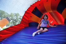 Sadie Thompson, daughter of U.S. Air Force Tech. Sgt. Robert Thompson, 55th Security Forces Squadron, poses for a photo on a slide during the Offutt Advisory Council’s annual Offutt Appreciation Day Picnic held at the Offutt Base Lake on Offutt Air Force Base, Nebraska, June 6.  More than 8,000 Team Offutt members and their families enjoyed a day that included free food, beverages and entertainment.  (U.S. Air Force photo by Charles Haymond/Released)