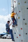U.S. Air Force Staff Sgt. Jeffery Tucker, U.S. Strategic Command, and his son Connor both climb the rock wall during the Offutt Advisory Council’s annual Offutt Appreciation Day Picnic held at the Offutt Base Lake on Offutt Air Force Base, Nebraska, June 6. More than 8,000 Team Offutt members and their families enjoyed a day that included free food, beverages and entertainment. (U.S. Air Force photo by Charles Haymond/Released)