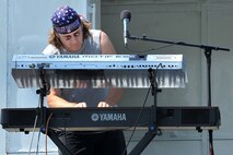Rick Moore, keyboardist with the Rick Spurgeon and Out of the Fire band, performs before the crowd during the Offutt Advisory Council’s annual Offutt Appreciation Day Picnic held at the Offutt Base Lake on Offutt Air Force Base, Nebraska, June 6. The members of Team Offutt and their families enjoyed a day that included free food, beverages and entertainment. (U.S. Air Force photo by Charles Haymond/Released)