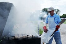 Doug Johnson, a volunteer at the Offutt Advisory Council’s Offutt Appreciation Day Picnic, cooks hundreds of hamburgers for Team Offutt members and their families at the Offutt Base Lake on Offutt Air Force Base, Nebraska, June 6. The OAC has coordinated this event for the members of Team Offutt and their families for 20 years. (U.S. Air Force photo by Charles Haymond/Released)