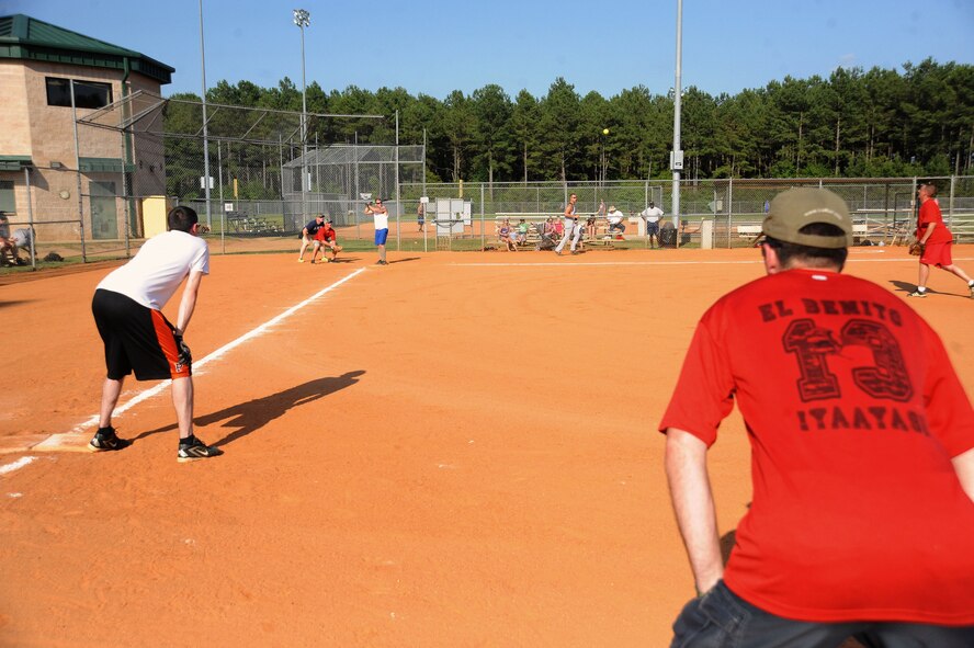 The 20th Operation Support Squadron and 20th Equipment Maintenance Squadron munitions flight softball teams play an intramural softball game at Shaw Air Force Base, S.C., June 16, 2014. Last years' champion were the munitions flight, with a record of 14-0. (U.S. Air Force photo by Airman 1st Class Michael A. Cossaboom/Released)