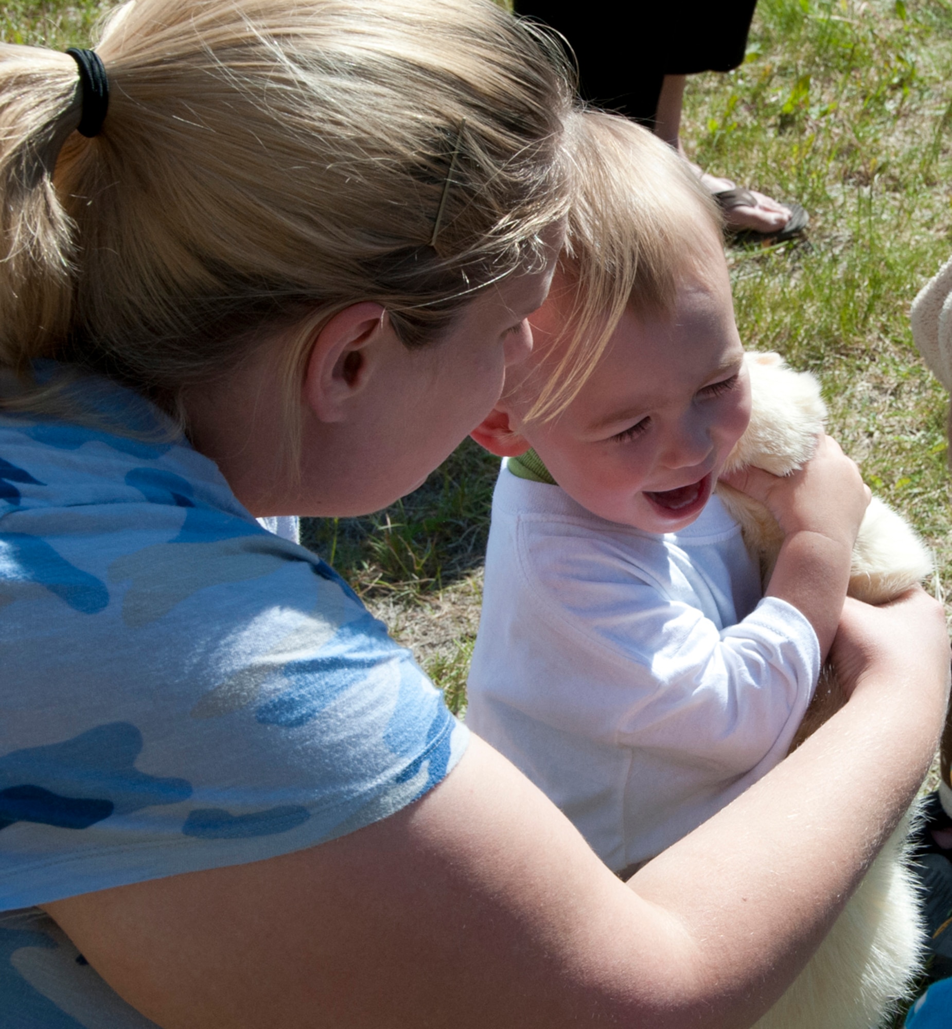 Gabriel Mays, son of Sgt. Charles Mays, 2nd Engineer Brigade, 17th Combat Sustainment Support Battalion truck driver, holds a ferret during one of the ‘Paws to Read’ events on Joint Base Elmendorf-Richardson, Alaska, June 5, 2014. Staff members read stories about animals that were present at the event, which children could see and touch. (U.S. Air Force photo/Airman 1st Class Tammie Ramsouer)