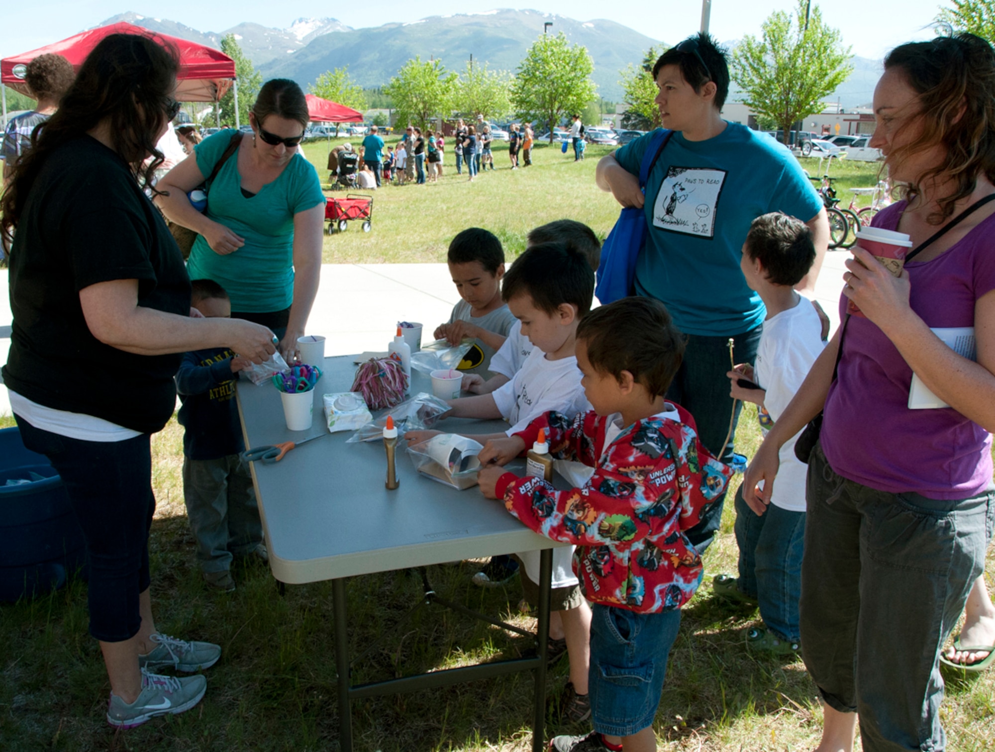 Children start an art project during one of the ‘Paws to Read’ events at the Consolidated Library on Joint Base Elmendorf-Richardson, Alaska, June 5, 2014. The art project was to make an animal with a Styrofoam cup, yarn and cardboard. (U.S. Air Force photo/Airman 1st Class Tammie Ramsouer)