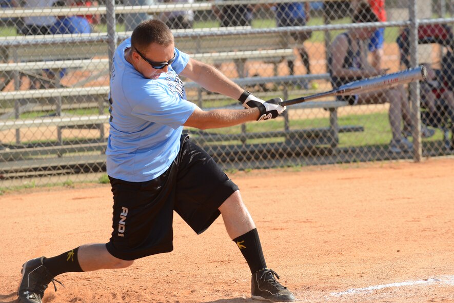 A U.S. Air Force Airman swings a bat during an intramural softball game at Shaw Air Force Base, S.C., June 16, 2014. U.S. Army Central “G2” played against U.S. Army Central “A2” during the second week of the softball season. All umpires are volunteers from different teams who follow the National Softball Association rule book. (U.S. Air Force photo by Airman 1st Class Diana M. Cossaboom/Released)
