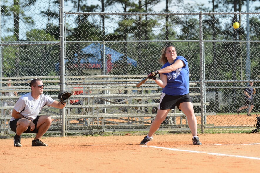 Alicia Burdick, spouse of U.S. Army Chief Warrant Officer 4 Edward Burdick, U.S. Army Central counter intelligence technician, swings at a softball during the ARCENT “G2” and U.S. Air Forces Central “A2” intramural softball game at Shaw Air Force Base, S.C., June 16, 2014. Twenty teams participated for this season which started in early June. (U.S. Air Force photo by Airman 1st Class Diana M. Cossaboom/Released) 