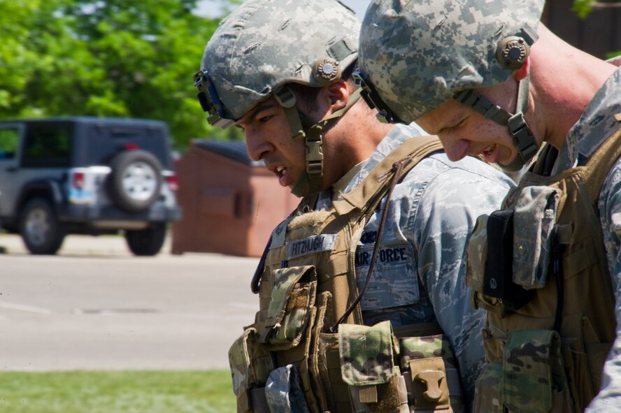 Members of the 791st Missile Security Forces Squadron carry a litter around the base track during the Top Dog competition at Minot Air Force Base, N.D., June 12, 2014. The flight with the best overall time wins bragging rights until the next Top Dog competition. (U.S. Air Force photo/Senior Airman Brittany Y. Bateman)