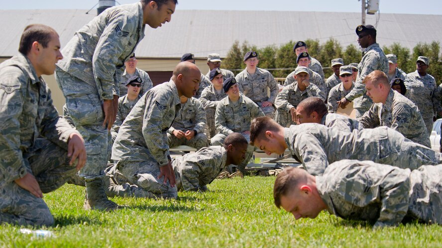 Members of the 791st Missile Security Forces Squadron perform push-up during the Top Dog competition at Minot Air Force Base, N.D., June 12, 2014. The competition is held quarterly as a way to boost morale throughout the squadron. (U.S. Air Force photo/Senior Airman Brittany Y. Bateman)