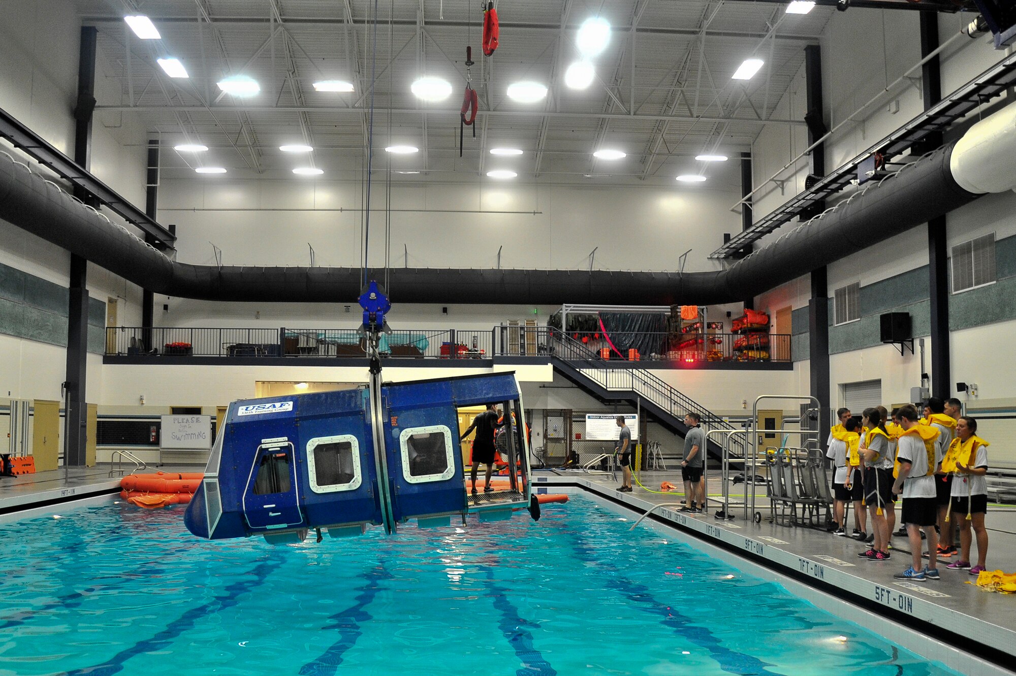 U.S. Air Force Academy and Reserve Officer Training Corps cadets wait as Airmen from the 66th Training Squadron prepares a water survival scenario for the cadets to experience at Fairchild Air Force Base, Wash., June 13, 2014. Several cadets came here for a two week program called Operation Air Force.  The program was created as a mandate in 2004 by the Secretary of the Air Force and the Chief of Staff of the Air Force to have cadets go out and experience day-to-day real world Air Force careers. (U.S. Air Force photo by Staff Sgt. Alexandre Montes/Released)