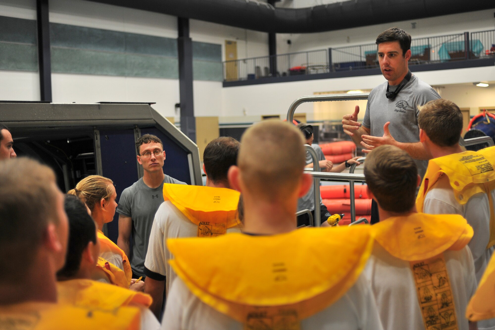 Staff Sgt. Andrew Blake, 66th Training Squadron water survival instructors, talks to U.S. Air Force Academy and Reserve Officer Training Corps cadets about water safety prior going through a water survival training scenario at Fairchild Air Force Base, Wash., June 13, 2014. Several cadets came here for a two week program called Operation Air Force.  The program was created as a mandate in 2004 by the Secretary of the Air Force and the Chief of Staff of the Air Force to have cadets go out and experience day-to-day real world Air Force careers. (U.S. Air Force photo by Staff Sgt. Alexandre Montes/Released)
