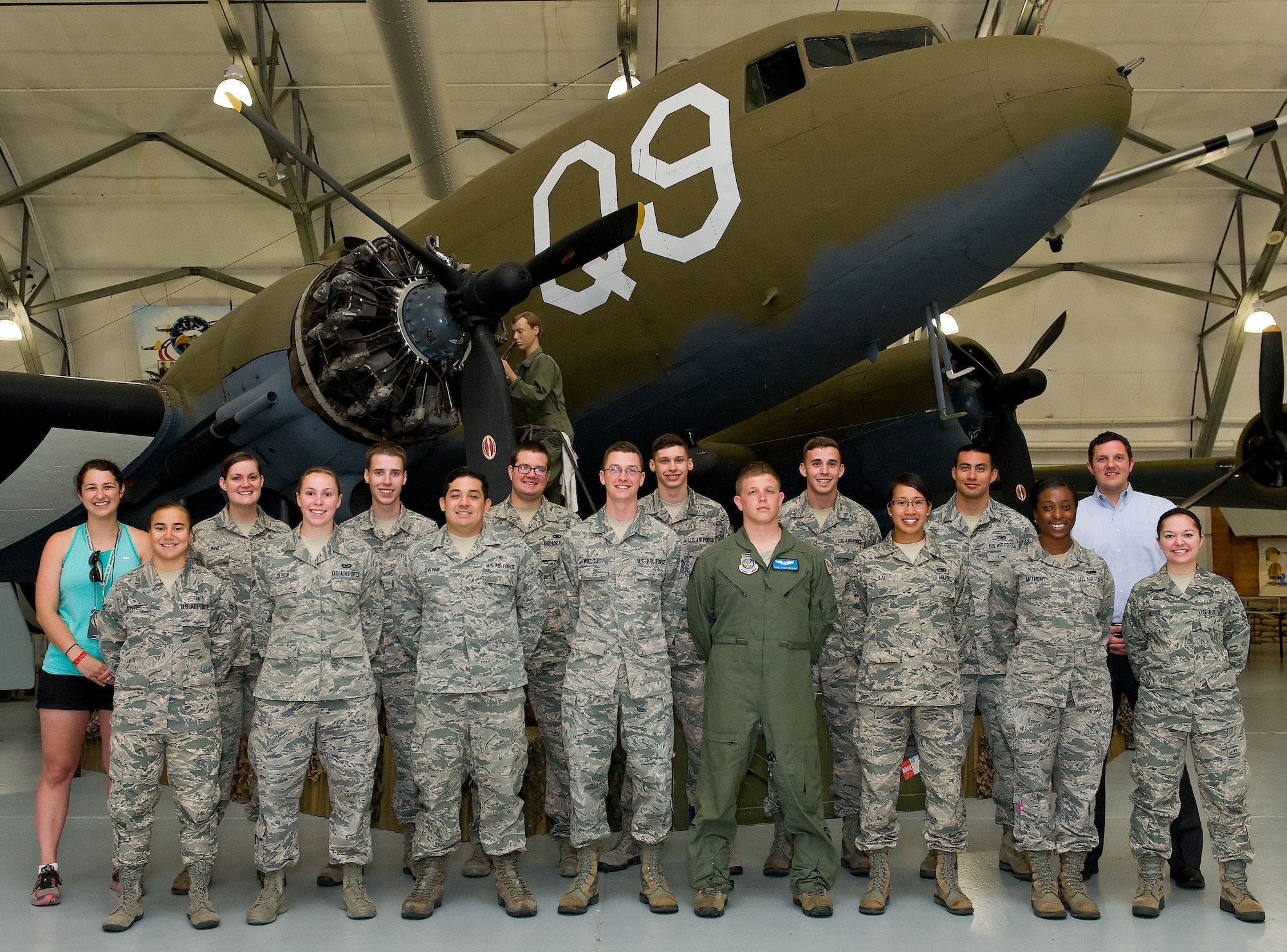 Sarah McGrath, back row left, Red Frog Events community relations director and Gary Camp, Dover International Speedway senior director of communications, pose for a photo with Team Dover members June 16, 2014, at the Air Mobility Command Museum on Dover Air Force Base, Del. McGrath and Camp presented 15 free tickets to the airmen for the upcoming Firefly Music Festival, June 19-22, at The Woodlands, Dover, Del. (U.S. Air Force photo/Roland Balik)