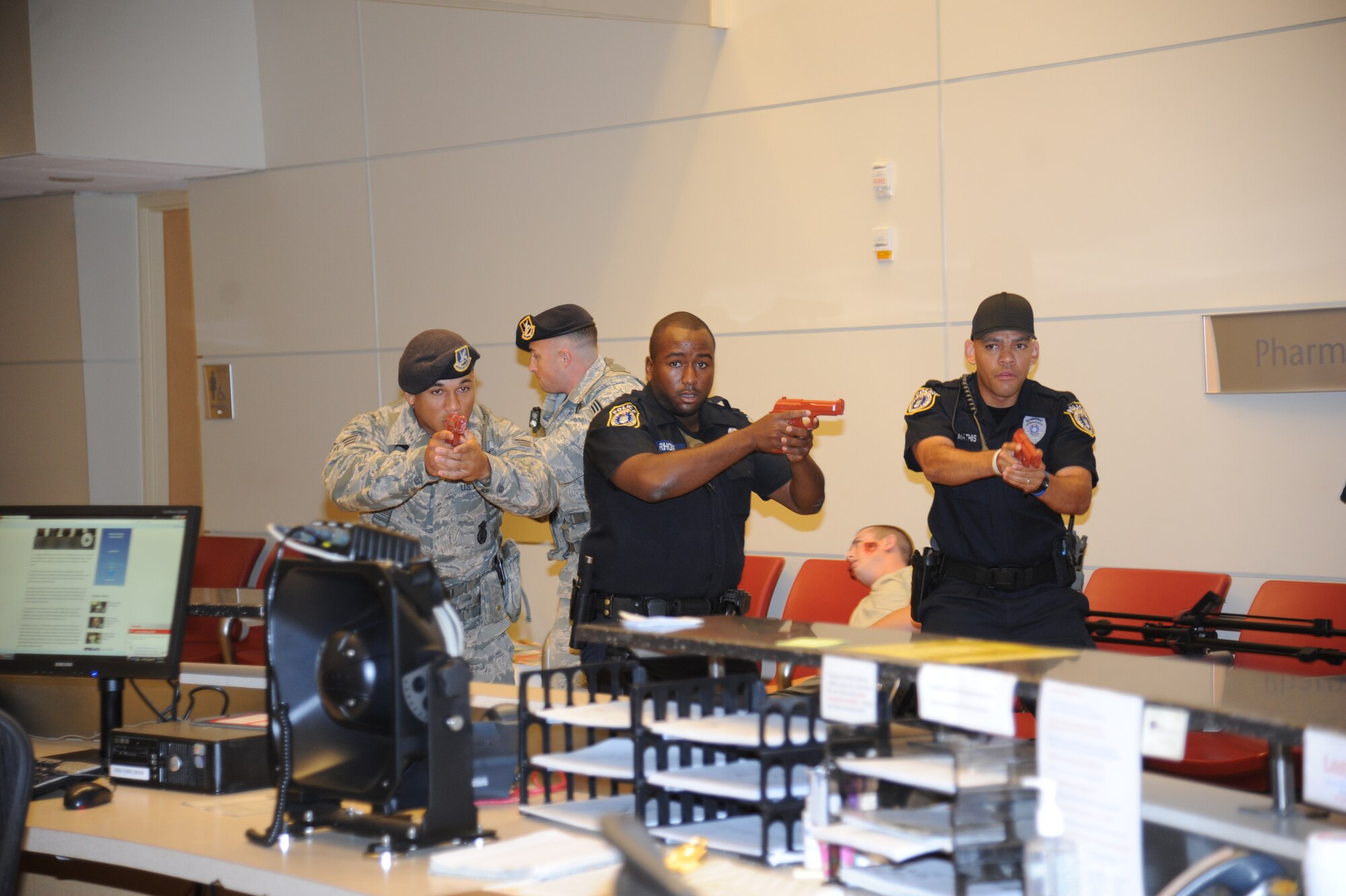 Members of the 81st Security Forces Squadron approach the room where a portrayed gunman has barricaded himself during Keesler's active shooter exercise, June 11, 2014, at the Keesler Medical Center, Keesler Air Force Base, Miss.  An Air Force student simulated opening fire at the hospital after feeling he was wrongfully diagnosed.  The exercise tested the base's ability to respond to and recover from a mass casualty event.  (U.S. Air Force photo by Kemberly Groue)