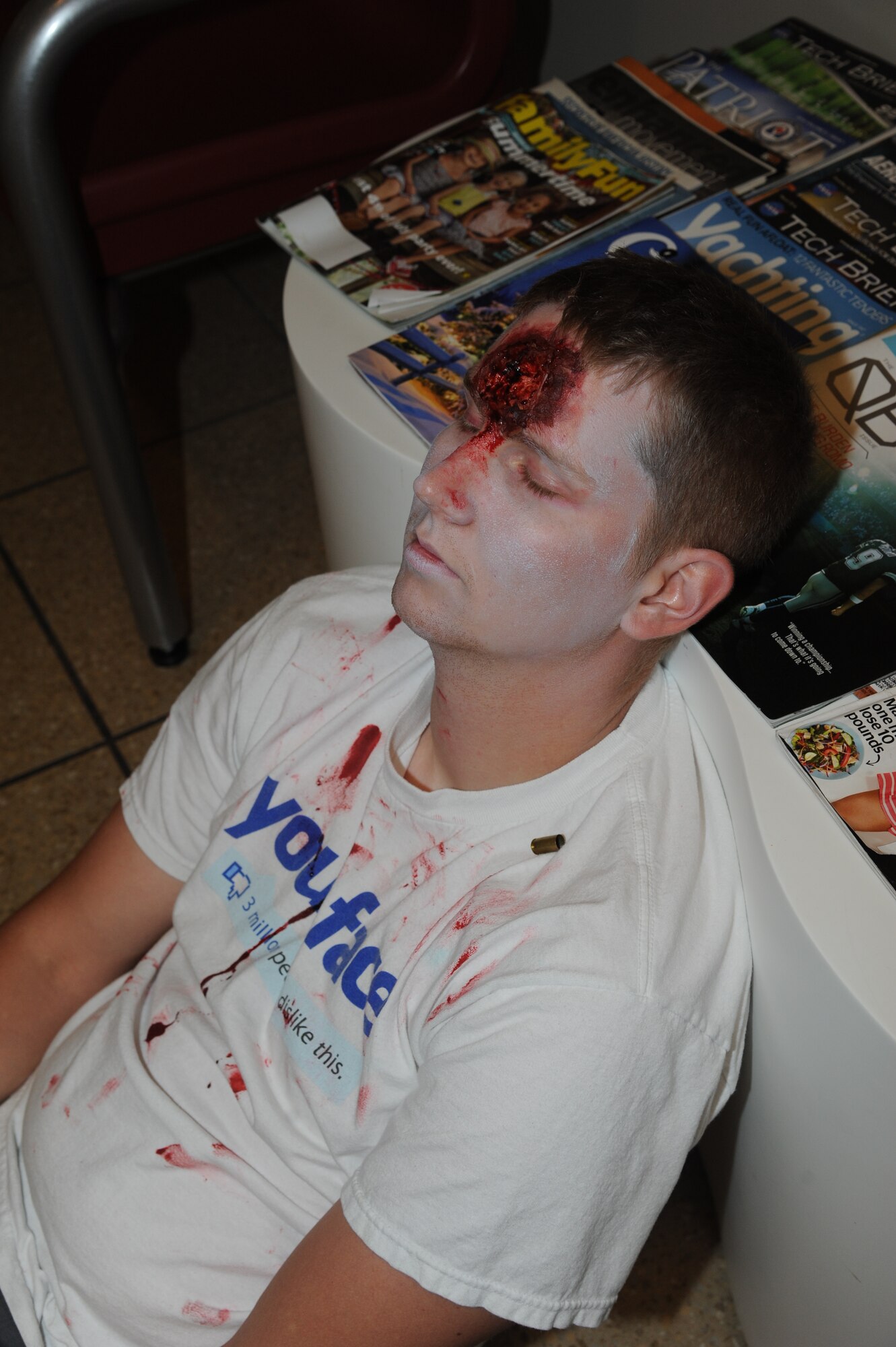 Senior Airman Tim Luttrell, 334th Training Squadron, portrays a victim that was killed by a portrayed gunman during Keesler's active shooter exercise, June 11, 2014, at the Keesler Medical Center, Keesler Air Force Base, Miss.  An Air Force student simulated opening fire at the hospital after feeling he was wrongfully diagnosed.  The exercise tested the base's ability to respond to and recover from a mass casualty event.  (U.S. Air Force photo by Kemberly Groue)