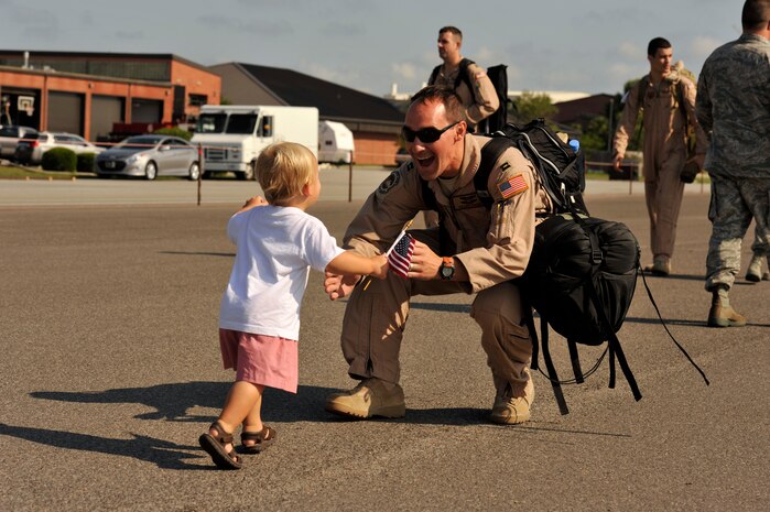 A 14th Airlift Squadron Airman greets his son, June 16, 2014, after returning home from Southeast at Joint Base Charleston, S.C. Deployed to the 816th Expeditionary Airlift Squadron,, the crews flew and supported 1,285 sorties, logged more than 3,000 combat flying hours and air-lifted more than 40 million pounds of cargo. (U.S. Air Force photo/Staff Sgt. Renae Pittman)