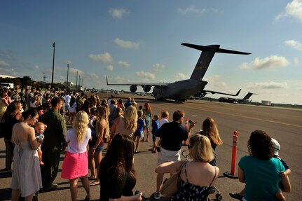 Families, friends and co-workers gather for the 14th Airlift Squadron's return from Southeast Asia, June 16, 2014, at Joint Base Charleston, S.C. Deployed to the 816th Expeditionary Airlift Squadron,  the crews flew and supported 1,285 sorties, logged more than 3,000 combat flying hours and air-lifted more than 40 million pounds of cargo. (U.S. Air Force photo/Staff Sgt. Renae Pittman)