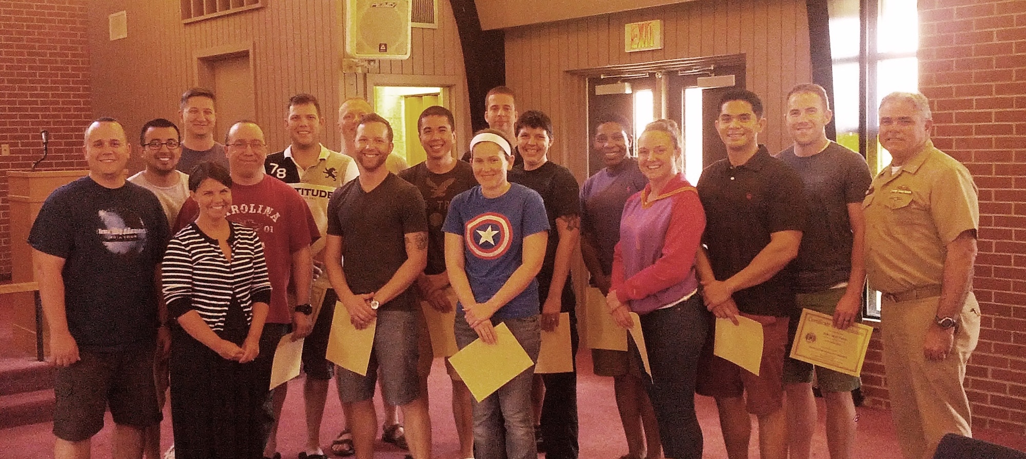 Capt. Timothy Sparks, Joint Base Charleston deputy commander (right) and Tiffany Mizzell, Naval Support Activity Charleston Sexual Assault Response Coordinator (third from left), proudly pose with the latest Victim Advocates who completed their 40-hour Sexual Assault Prevention and Response Victim Advocate Training, June 13, 2014, at the Good Shepherd Chapel at the Weapons Station. (Courtesy photo) 

