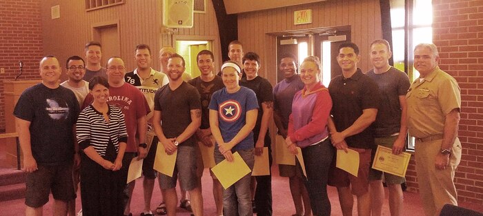 Capt. Timothy Sparks, Joint Base Charleston deputy commander (right) and Tiffany Mizzell, Naval Support Activity Charleston Sexual Assault Response Coordinator (third from left), proudly pose with the latest Victim Advocates who completed their 40-hour Sexual Assault Prevention and Response Victim Advocate Training, June 13, 2014, at the Good Shepherd Chapel at the Weapons Station. (Courtesy photo) 


