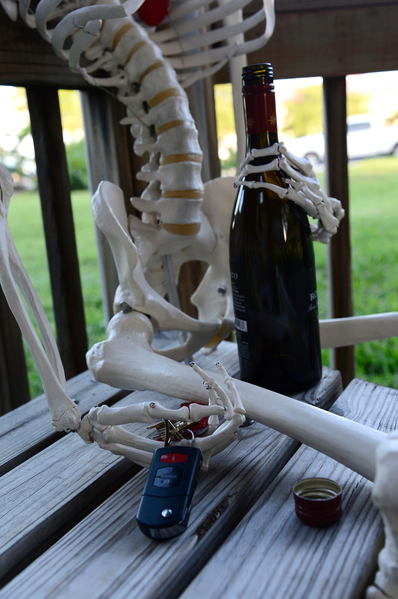 MacBones, 6th Air Mobility Wing safety skeleton, holds a bottle of alcohol and car keys at MacDill Air Force Base, Fla., June 17, 2014. If you’re going to drink, don’t drive- If you’re going to drive, don’t drink. (U.S. Air Force photo by Airman 1st Class Tori Schultz/Released)