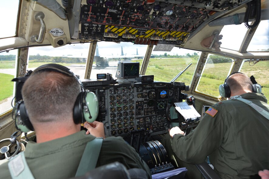 U.S. Air Force Lt. Col. Greg Stewart (left), pilot, and Maj. Tom Kampmeyer, co-pilot, both assigned to the 180th Airlift Squadron, Missouri Air National Guard, prepare for take off in Cherbourg, France, June 4, 2014.  An aircrew from the Missouri Air National Guard participated in flyovers in Normandy, France, as part of the 70th anniversary of D-Day. (U.S. Air National Guard photo by Tech. Sgt. Michael Crane/Released)