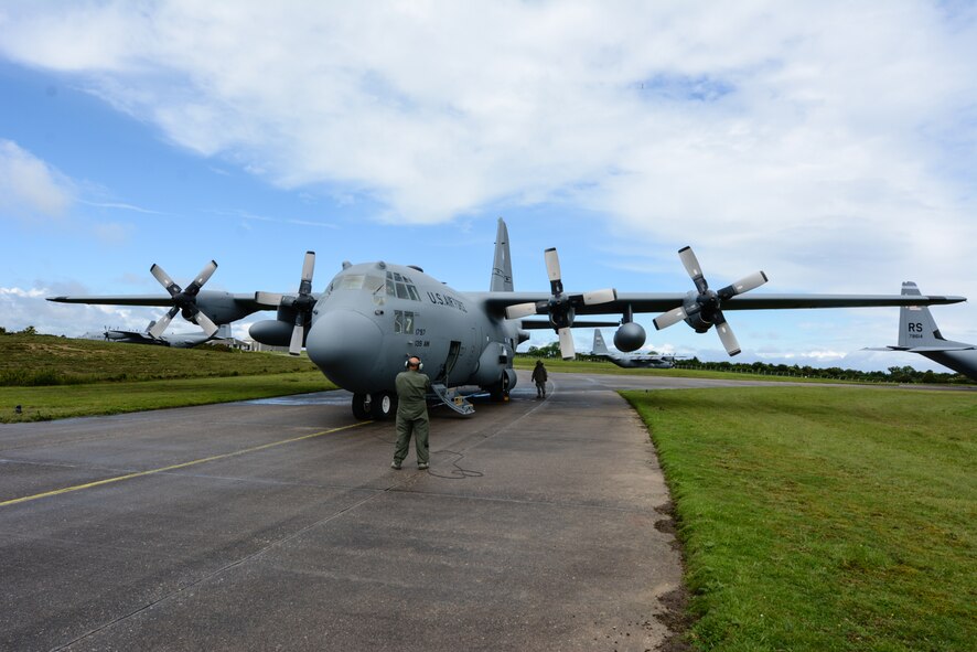 U.S. Air Force Senior Master Sgt. Pat Rock, a loadmaster assigned to the 180th Airlift Squadron, Missouri Air National Guard, helps prepare a C-130 Hercules aircraft for take off in Cherbourg, France, June 4, 2014. Aircrews from the Missouri National Guard’s 139th Airlift Wing and Nevada National Guard’s 152nd Airlift Wing participated in flyovers as part of a weeklong celebration of the 70th anniversary of D-Day. (U.S. Air National Guard photo by Tech. Sgt. Michael Crane/Released)