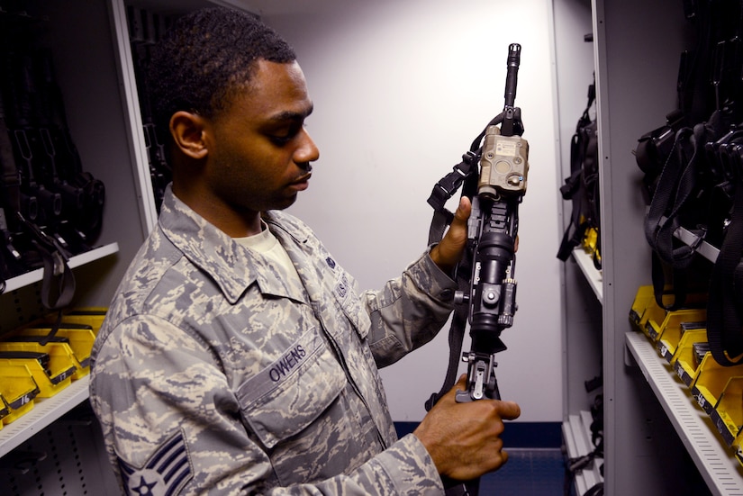U.S. Air Force Staff Sgt. Steven Owens, 633rd Security Forces Squadron armory assistant noncommissioned officer in charge, inspects an M4 carbine rifle at the squadron armory at Langley Air Force Base, Va., June 11, 2014. Owens said the armorers are an essential asset to mission success at home and abroad, as they serve as the focal point for all combat firepower for Langley Airmen. (U.S. Air Force photo by Senior Airman Jason J. Brown/Released)