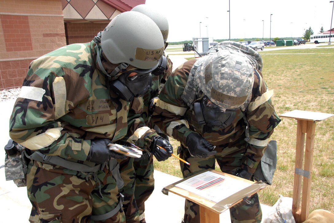 Ohio Air National Guard airmen from the 178th Communications Flight, compare results of a Liquid Detection Point with their AF-PAM 10-100 June 10, 2014, at Alpena Combat Readiness Training Center, Alpena, Mich.  The airmen checked the LDPs as members of a Post Attack Reconnaissance team during the unit’s Operational Readiness Exercise. (Ohio Air National Guard photo by Master Sgt. Seth Skidmore/Released)