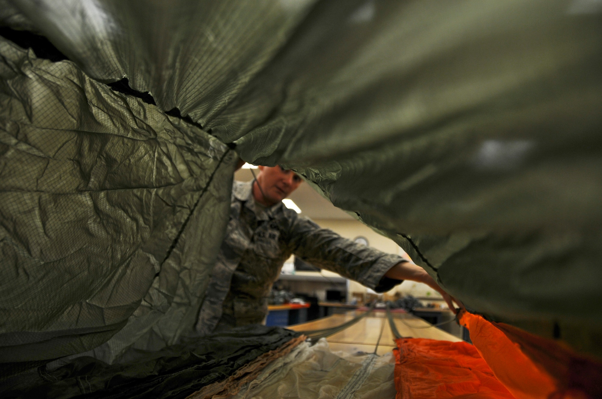 Staff Sgt. Kimberly Robinson, 911th Operations Support Squadron aircrew flight equipment technician, inspects a BA-22 parachute at the Pittsburgh International Airport Air Reserve Station, June 6, 2014. Parachutes are required to be inspected annually for safety and readiness. During the inspection, aircrew flight equipment technicians check the parachutes for damage and ensure that all of the release mechanisms are working properly. (U.S. Air Force photo by Senior Airman Joshua J. Seybert)