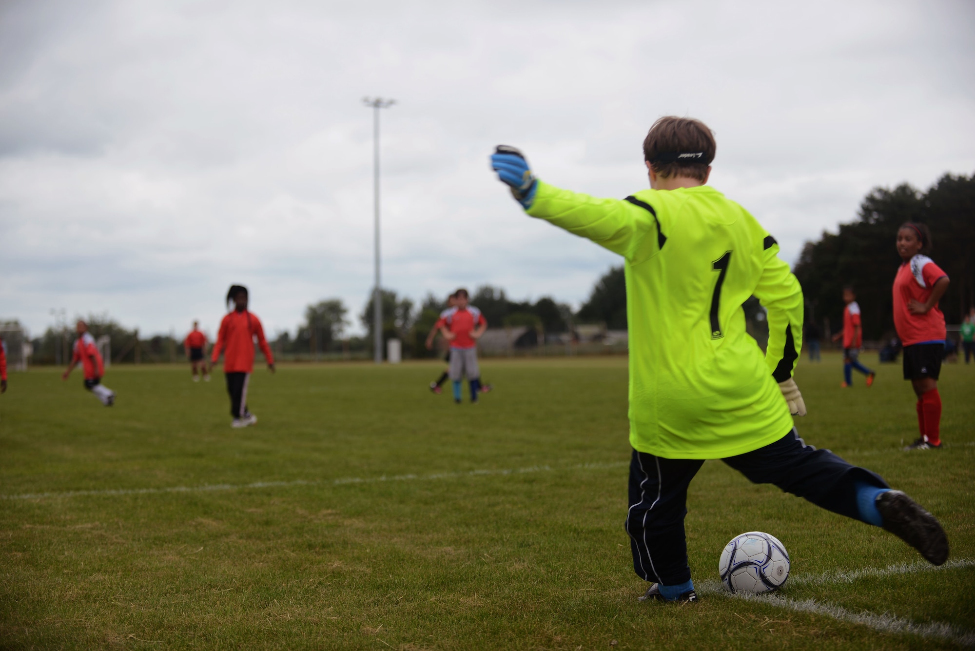 The goalie for the Red Dragons, Team Mildenhall’s youth all-star soccer team, kicks a ball to his teammates June 14, 2014, at Heritage Park on RAF Mildenhall, England. The match between Team Mildenhall and the RAF Lakenheath Liberty Wing youth allowed the children one last opportunity to play together after the end of the season. (U.S. Air Force photo/Airman 1st Class Preston Webb/Released)
