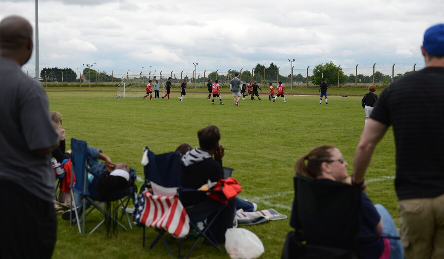 Parents from Team Mildenhall and the RAF Lakenheath Liberty Wing watch their children play soccer June 14, 2014, at Heritage Park on RAF Mildenhall, England. Because soccer is a popular sport in the Caribbean, the RAF Mildenhall Caribbean-American Heritage Association sponsored the all-star match in conjuction with the Air Force Sergeants Association in recognition of Caribbean American Heritage Observance Month. (U.S. Air Force photo/Airman 1st Class Preston Webb/Released)