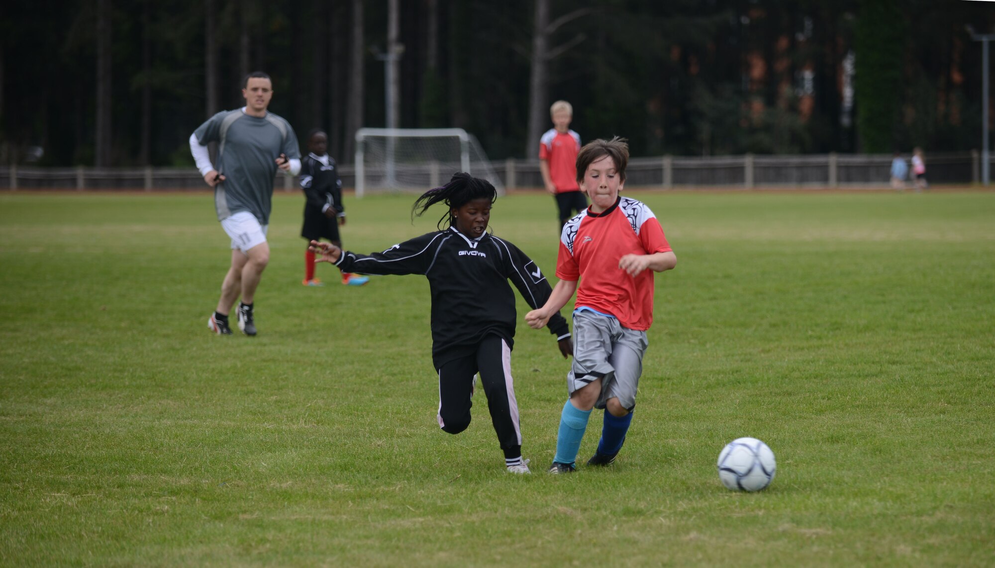 Members of the Team Mildenhall’s and the RAF Lakenheath Liberty Wing’s youth all-star soccer teams, run to a ball June 14, 2014, at Heritage Park on RAF Mildenhall, England. Children ages 9 to 11 played in the all-star match. (U.S. Air Force photo/Airman 1st Class Preston Webb/Released)
