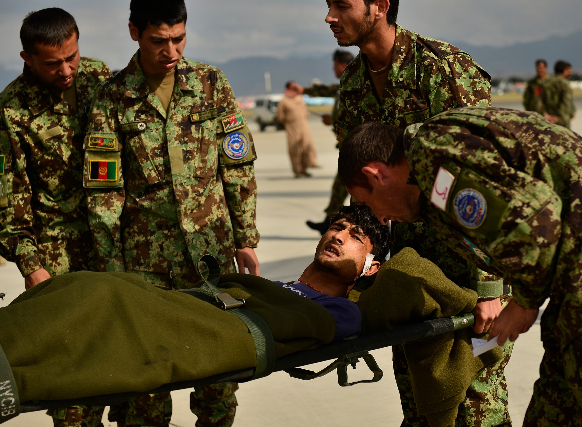 Afghan National Army soldiers transport an injured ANA soldier at the conclusion of a casualty evacuation, Kabul, Afghanistan, May 19, 2014. The Afghan aircrew successfully loaded the human remains, ANA soldiers and other personnel seamlessly. The aircrew assisted 16 injured patients onto stretchers and into safe positions during the flight.  (U.S. Air Force photo by Staff Sgt. Vernon Young Jr.)